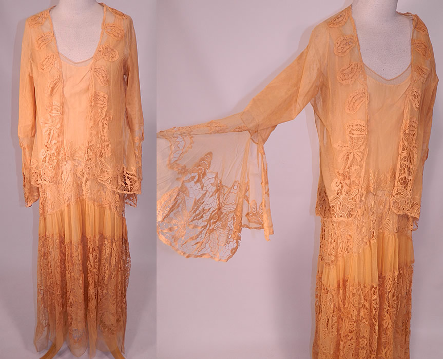 Vintage Peach Net Battenburg Lace Drop Waist Dress Silk Slip & Jacket Outfit
This exceptional vintage peach net Battenburg lace drop waist dress, silk slip and jacket three piece outfit dates from the 1920s. It is made of a light yellowish pink peachy cream color sheer silky net lace fabric with Battenburg tape lace floral leaf pattern designs and connecting brides and bars.