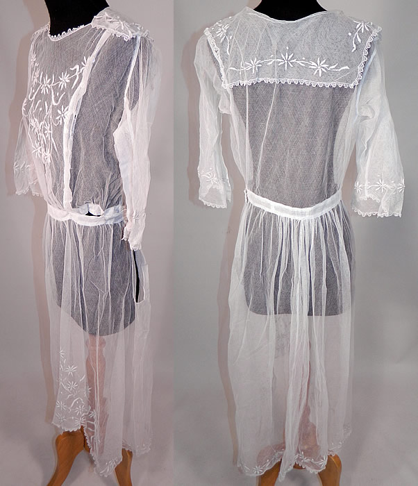 Vintage Edwardian Sheer White Net Floral Embroidered Lace Middy Dress
This lovely lace middy dress is a long mid length with an uneven high low skirt longer in the back, has a middy style sailor collar top, with 3/4 length sleeves, wide flared bell shape cuffs, a fitted waistband, hook closures down the front side and is sheer, completely unlined.
