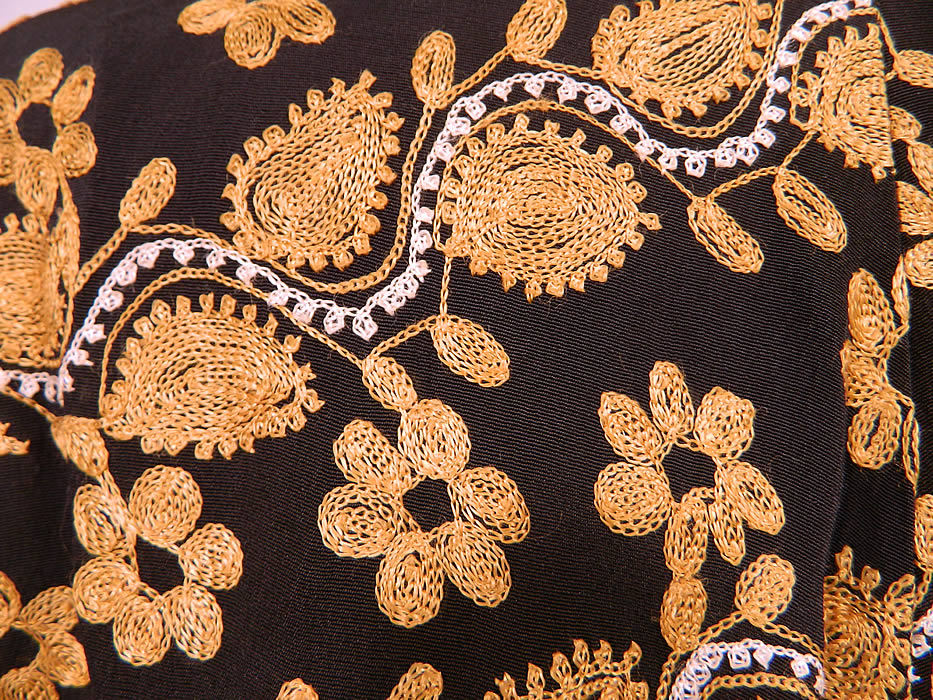 Vintage Black Silk Rayon Chain Stitch Crewel Work Embroidery Swing Coat Jacket.
It is in good condition, with only some fraying on the inside lining seams and button trim. This is truly a wonderful piece of wearable art! 