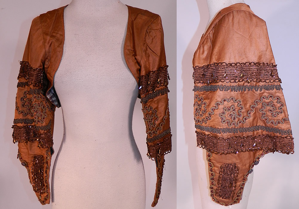 Victorian Civil War Brown Silk Bronze Beaded Bodice Bolero Cropped Spencer Jacket
This antique Victorian Civil War era brown silk bronze beaded bodice bolero cropped spencer jacket dates from the 1860s. It is made of a brown silk fabric, with gold braided soutache embroidery work and bronze beading.