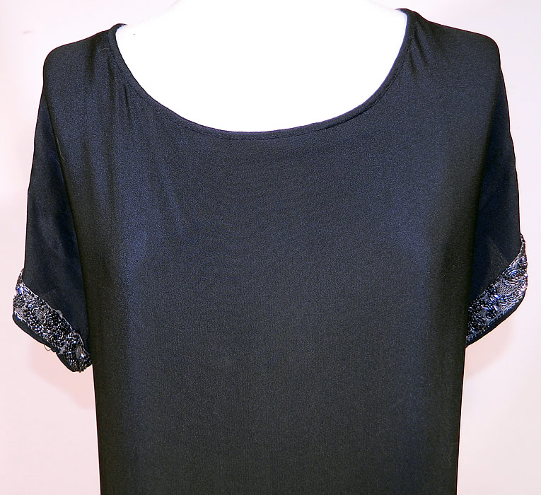 Vintage Art Deco Black Silk Crepe de Chine Tiered Panel Skirt Beaded Flapper Dress
This fabulous flapper dress is loose fitting, with a drop waist, a layered tiered panel skirt, short sleeves, snap closures on the back and is unlined. 