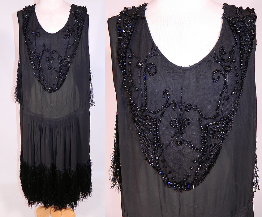 Vintage Art Deco Black Silk Jet Beaded Fringed Flapper Drop Waist Dress
This vintage Art Deco black silk jet beaded fringed flapper drop waist dress dates from the 1920s. It is made of a black sheer silk chiffon fabric, with a jet beaded front bib neckline top backed in net and black silk hand knotted fringe hanging down the back and around the bottom skirt.