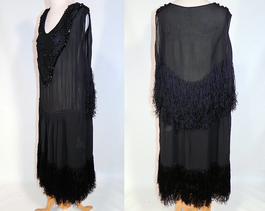 Vintage Art Deco Black Silk Jet Beaded Fringed Flapper Drop Waist Dress
This fabulous flapper dress has a loose fitting drop waist style, with ruched smocking around the mid section, sleeveless, with wide open arm holes, a rounded low front scoop neckline and is lined. 