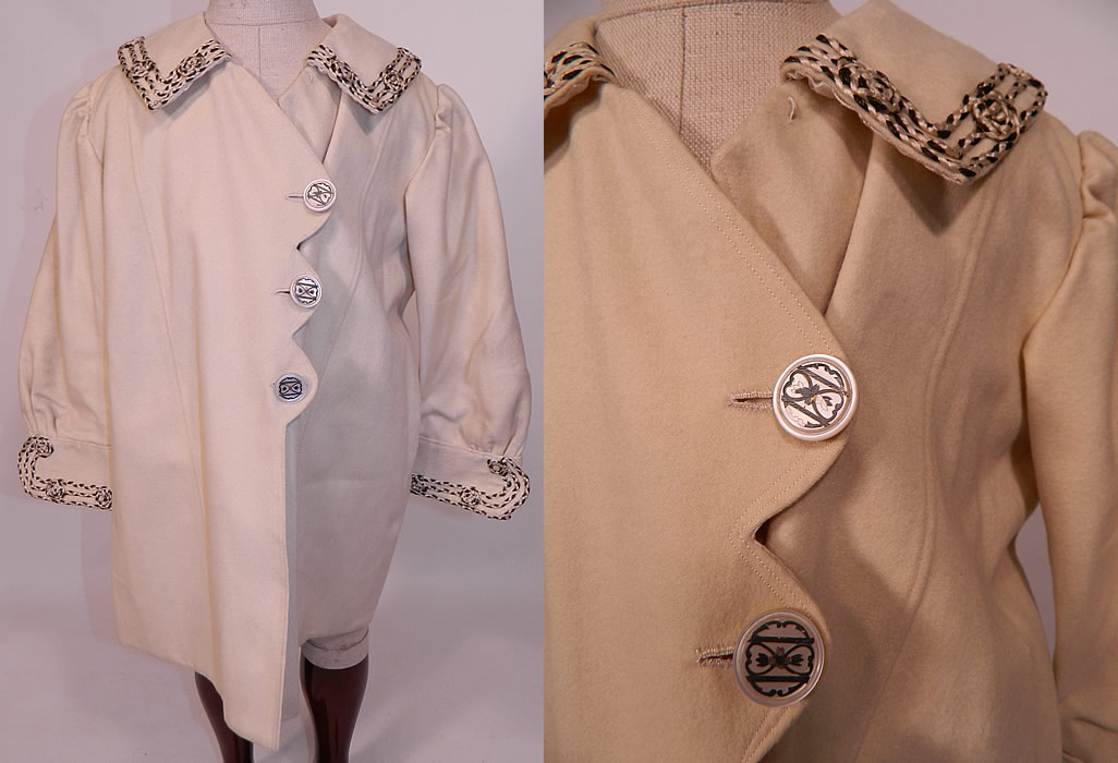 Edwardian White Wool Silver Soutache Braided Trim Childs Winter Coat
This antique Edwardian era white wool silver soutache braided trim child's winter coat dates from 1910. It is made of a white fine soft wool fabric, with silver and white silk soutache braided rope trim edging with knotted rosette accents.