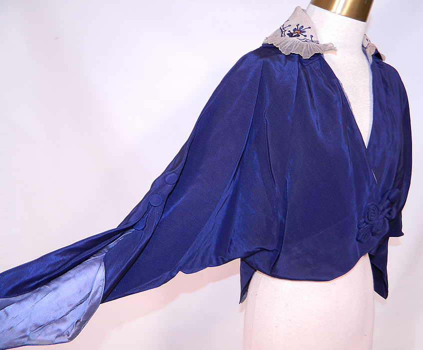 Titanic Era Edwardian Blue Silk Dolman Sleeve Short Crop Coat Bolero Jacket

It is made of a dark blue silk fabric, with a white silk, colorful chain stitch embroidered, net ruffle trim collar.