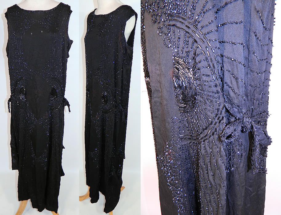 Vintage Art Deco Black Silk Jet Beaded Flapper Drop Waist Side Tie Dress Evening Gown
This vintage Art Deco black silk jet beaded flapper drop waist side tie dress evening gown dates from the 1920s. It is made of a black silk fabric, with jet bead work done in an amazing Art Deco circular, striped, sunburst designs.