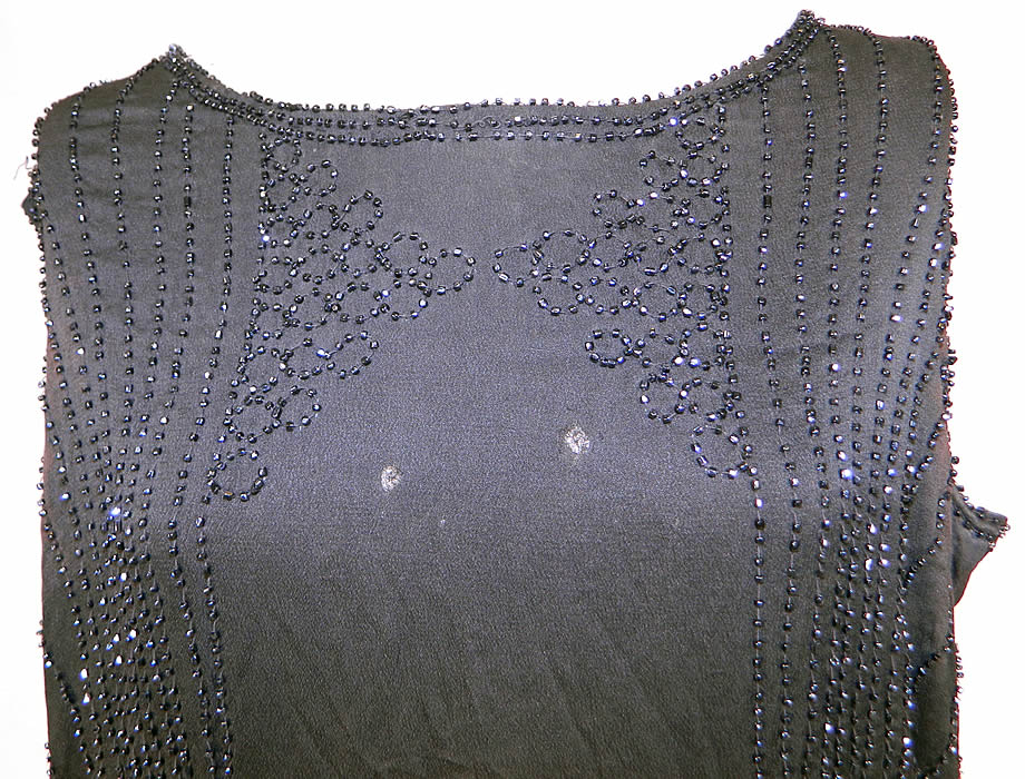 Vintage Art Deco Black Silk Jet Beaded Flapper Drop Waist Side Tie Dress Evening Gown
It is in good condition, with only a few loose missing beads, faint underarm discoloration and two tiny holes on the front top (see close-up). Great for design! This is truly a wonderful piece of Art Deco wearable beaded textile art! 