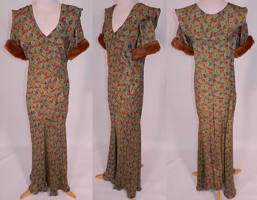 Vintage Green Gold Lam&eacute; Lame Floral Print Bias Cut Gown Shawl Collar Fur Trim Cuffs
This vintage green gold lam&eacute; floral print bias cut gown shawl collar, fur trim cuffs dates from the 1930s. It is made of a olive green color silk lam&eacute; fabric with gold metallic thread woven through it and a red, white, blue floral leaf print pattern design.