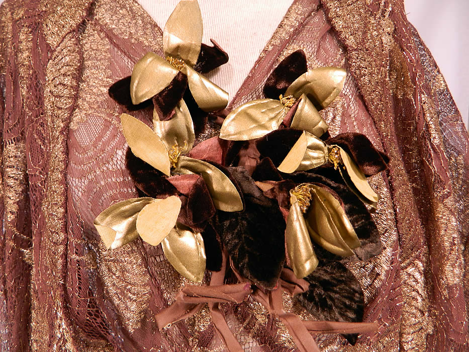 Vintage Gold Lame Brown Lace Flower Bias Cut Dress Jacket Evening Gown Lam&eacute;
There are gold metallic, brown velvet flower trim sewn onto the front top. This gorgeous gown has a fitted bias cut style, with a long full floor length skirt, sleeveless, plunging V necklines, a belted waist with buckle clasp, side snap closures and is sheer, unlined. 