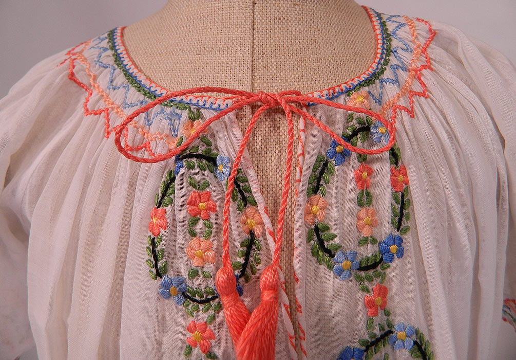 Vintage Childs White Cotton Colorful Embroidered Smocking Hungarian Peasant Dress
The dress measures 24 inches long, with a 22 inch waist and chest. It is in excellent condition. This is truly a wonderful piece of wearable bohemian peasant textile folk art!