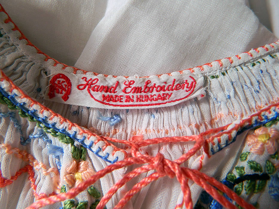 Vintage Childs White Cotton Colorful Embroidered Smocking Hungarian Peasant Dress
There is a "Hand Embroidery Made in Hungary" label sewn inside. 