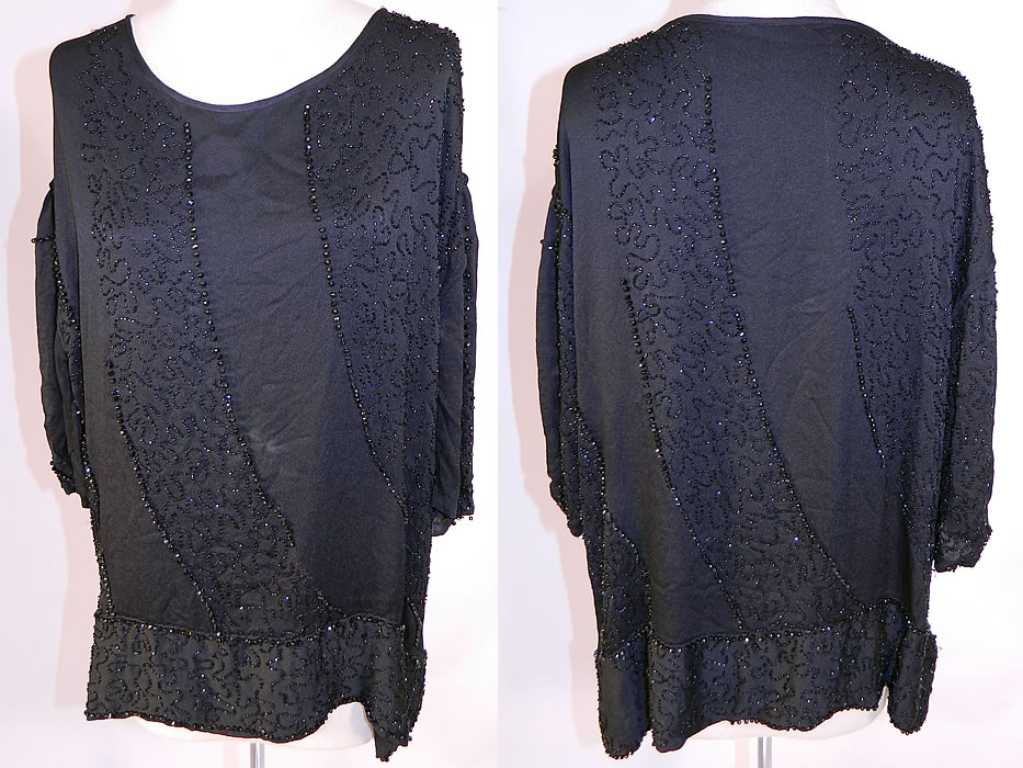 Vintage Art Deco Black Silk Jet Beaded Flapper Blouse Shirt Tunic Top
This vintage Art Deco black silk jet beaded flapper blouse shirt tunic top dates from the 1920s. It is made of a black silk crepe de chine fabric, with black jet beading done in Art Deco abstract spiral scrolling striped pattern design. This beautiful beaded blouse has a long loose fitting tunic top style, with a beaded trim skirted band bottom hem and 3/4 length long full sleeves.