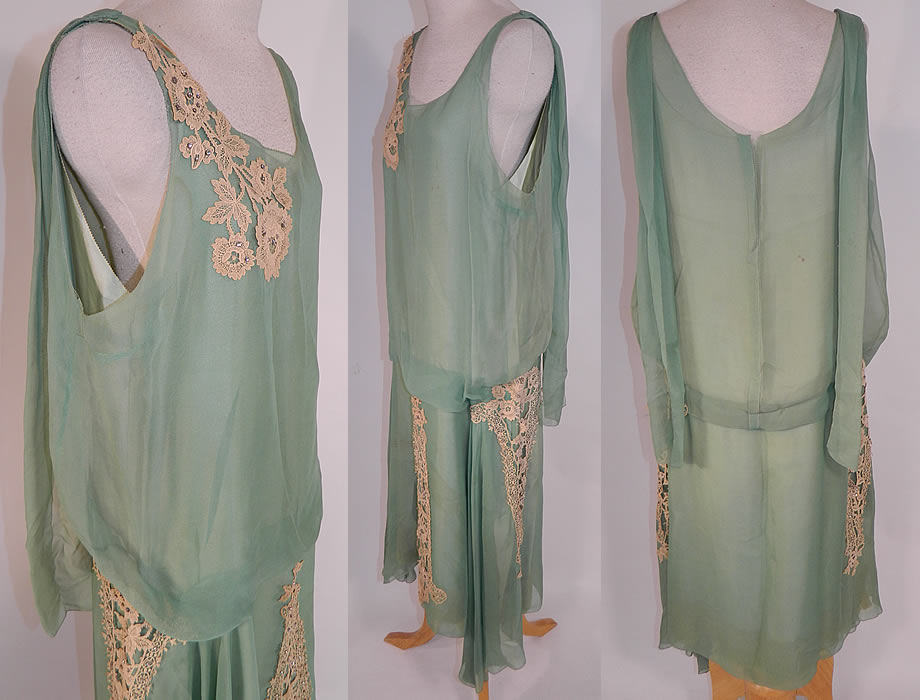 Vintage Mint Green Silk Chiffon Lace Applique Rhinestone Trim Drop Waist Dress
This fabulous flapper dress is loose fitting, with a drop waist, sleeveless top, an uneven asymmetrical handkerchief hemline skirt, scarf panels hanging down from the back shoulders and is fully lined in a mint green silk slip sewn inside. 