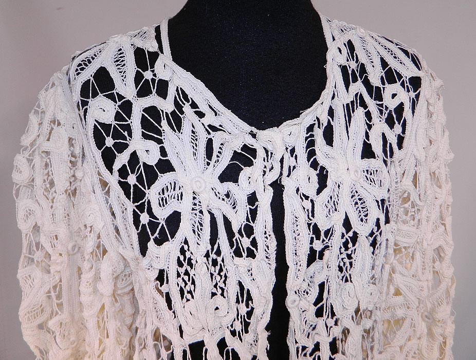 Edwardian Antique Cream Battenburg Crochet Tape Lace Coat Jacket
This lovely lace loose fitting coat jacket is a long mid length, with an open front, no closure, long full sleeves, with wide flared uneven cuffs and is sheer completely unlined.