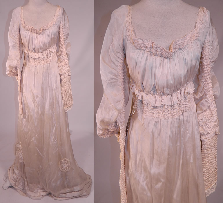 Edwardian Cream Silk Ruched Pearl Beaded Lace Trim Wedding Gown Train Skirt Dress
This antique Edwardian era cream silk ruched pearl beaded lace trim wedding gown train skirt dress dates from 1910. It is made of a cream silk fabric, with ruched tucks gathering on the sleeves, neckline, waist and drawn cut work, pearl beading, lace cobweb rosette appliqu&eacute; trim accents on the skirt. 