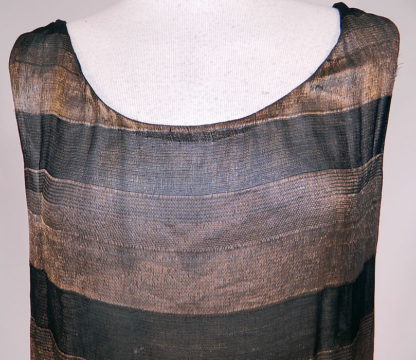 Vintage Art Deco Black & Gold Lame Silk Stripe Flapper Tunic Top Dress Lam&eacute;
The dress measures 26 inches long, with a 34 inch waist and 32 inch bust. It is in good condition, with only some tarnish discoloration. This is truly a wonderful piece of wearable Art Deco textile art! 