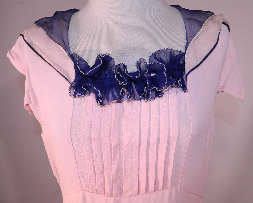 Vintage Pink Silk Crepe Navy Blue Ruffle Collar Cuffs Bias Cut Day Dress & Jacket
This pretty in pink delightful day dress has a bias cut, with short mid length skirt, short cap sleeves and sailor style collar. The dress measures 43 inches long, with 34 inch hips, a 24 inch waist and 34 inch bust.