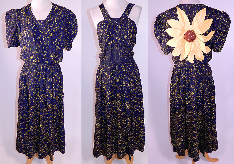 Vintage Navy Blue Yellow Sunflower Novelty Print Silk Sun Dress & Jacket
This vintage navy blue yellow sunflower novelty print silk sun dress and jacket dates from the 1940s. It is made of a navy blue and yellow sunflower print silk fabric, with a large yellow sunflower appliqu&eacute; pinned onto the back jacket. This sensational summer sun dress has a halter top style with shoulder straps, a short mid length full skirt and side hook closures. 