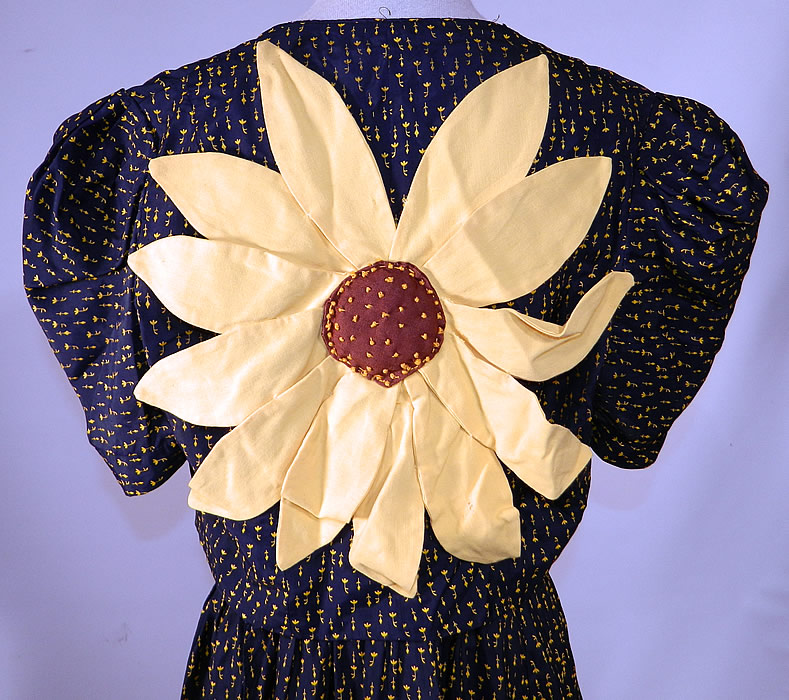 Vintage Navy Blue Yellow Sunflower Novelty Print Silk Sun Dress & Jacket
The jacket measures 15 inches long, with a 24 inch waist and 32 inch bust. It is in good condition, but does have some wear to the fabric on the front waist where the yellow floral pattern print has faded, rubbed off (see close-up). This is truly a wonderful piece of wearable art! 