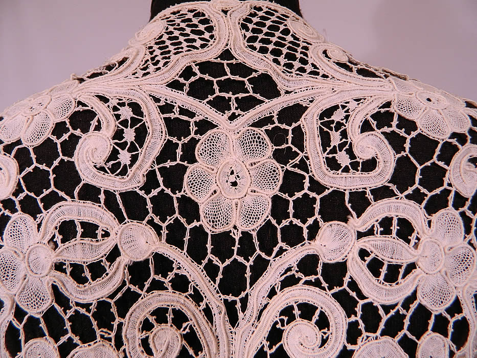 Vintage Edwardian Antique White Bobbin Lace Long Coat Jacket
This lovely lace coat jacket is a long mid length, with an open front, no closure, long full flared wide bell shaped sleeves, scalloped edge trim and is sheer completely unlined.