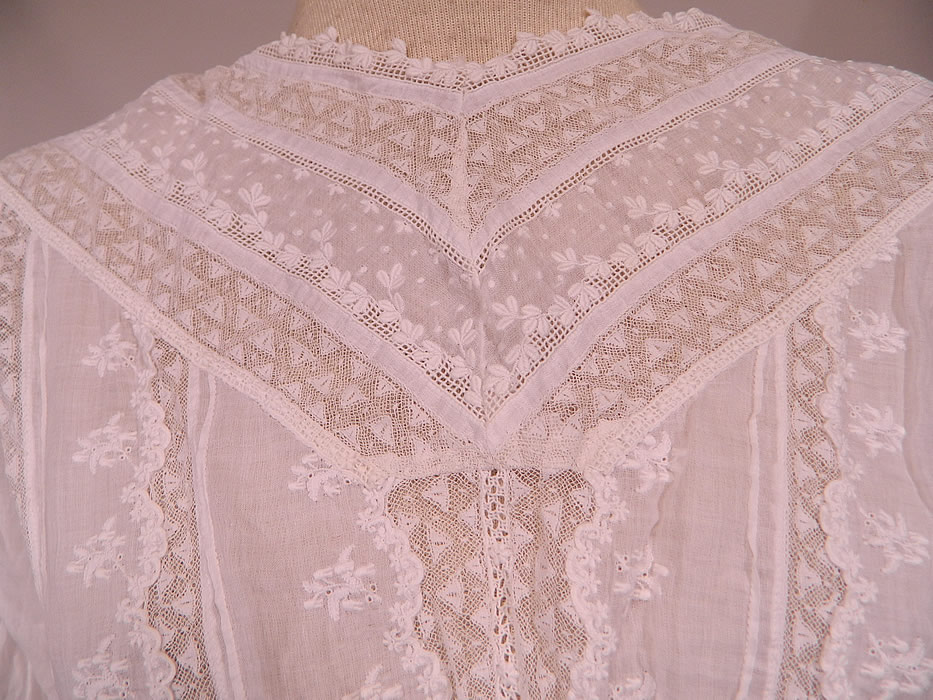 Victorian Lace Embroidered White Cotton Batiste Wedding Dress Polonaise Overdress Skirt
This beautiful bridal wedding gown has a polonaise style overdress bodice, with 3/4 length sleeves, a fitted waist, mother of pearl buttons, hook closures down the back and is sheer, completely unlined.