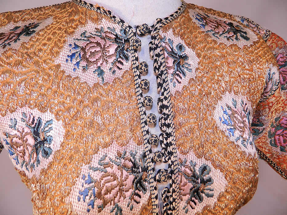 Antique Bukhara Uzbekistan Gold Lam&eacute; Lame Brocaded Childs Chapan Coat
This exquisite charming child's chapan caftan coat robe has a black & white silk braided rope trim edging, with knotted round button toggle loop closures down the front, long full sleeves and is fully lined in a lilac color silk fabric. 
