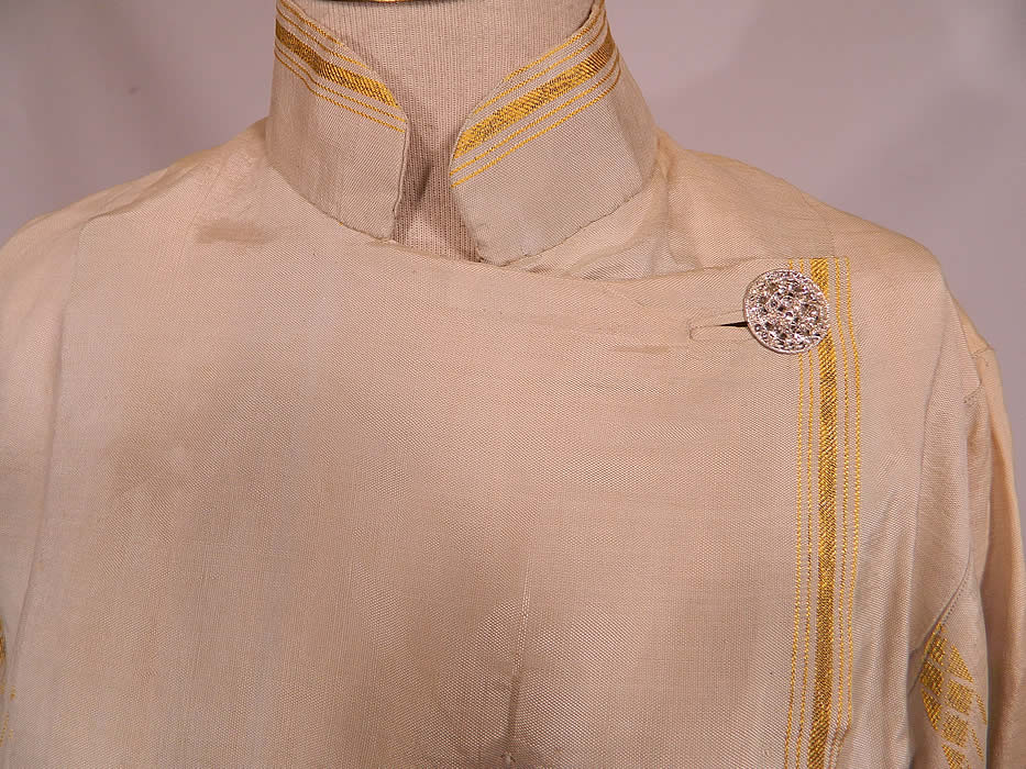 Vintage L.M. Rosen Gowns NY Label Art Deco Gold Lame Blue Silk Evening Coat Lam&eacute;
This elegant evening coat is loose fitting with a long length, full boxy style, mandarin collar, long full sleeves, bottom side slits, silver filigree rhinestone button closures along the side and is fully lined in a cream silk satin fabric.