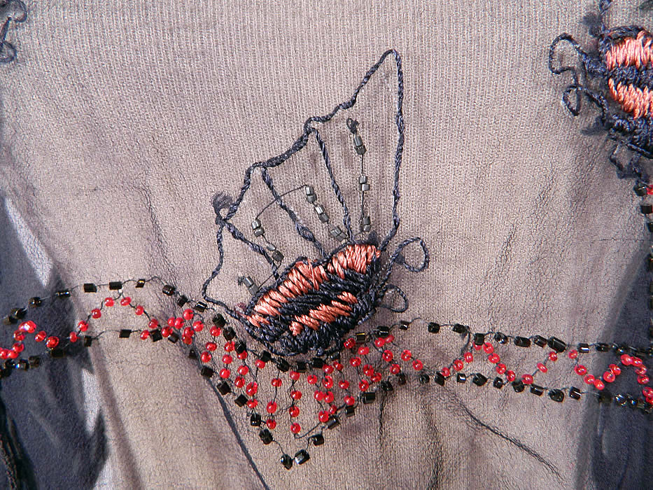 Vintage Navy Blue Sheer Silk Chiffon Embroidered Beaded Butterfly Blouse Shirt
This beautiful beaded blouse flapper shirt top has long full sleeves, with ruffle cuffs, a fitted waistband, side button closures and is sheer, unlined.