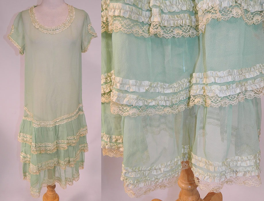 Vintage Mint Green Silk Chiffon Lace Ribbon Ruched Ruffle Trim Drop Waist Dress
This vintage mint green silk chiffon lace ribbon ruched ruffle trim drop waist dress dates from the 1920s. It is made of a pastel mint green color sheer silk chiffon fabric, with cream color lace and pale green silk ruched ribbon ruffle trim edging.
