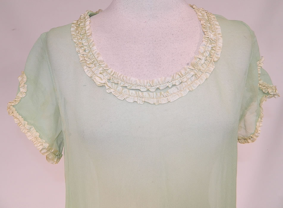 Vintage Mint Green Silk Chiffon Lace Ribbon Ruched Ruffle Trim Drop Waist Dress
This pretty pastel green flapper dress has a loose fitting drop waist style, with a rounded scoop neckline, short cap sleeves, layered tiered ruffle skirt and is sheer, unlined. The dress measures 40 inches long, with 34 inch hips, a 34 inch waist and 34 inch bust.