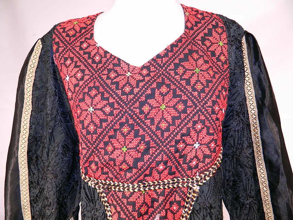 Vintage Al-Karnak Jordan Bedouin Kaftan Jalabiya Thobe Embroidered Maxi Dress
There is a gold metallic lam&eacute; and rope trim edging. This beautiful bedouin kaftan maxi dress is a long floor length, loose fitting with a belted tie back, long kimono style sleeves with exaggerated points along the bottom and is unlined. 