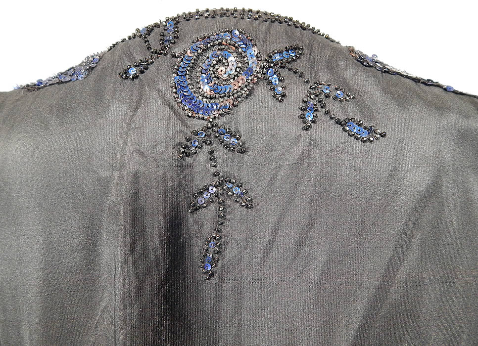 Vintage Art Deco Black Silk Taffeta Blue Sequin Beaded Flapper Dress Evening Gown
The dress is a large size measuring 52 inches long, with 40 inch hips, a 40 inch waist and 40 inch bust. It is in good condition, with only the inside lining has some frayed rips on the net fabric. This is truly a wonderful piece of Art Deco wearable beaded textile art!