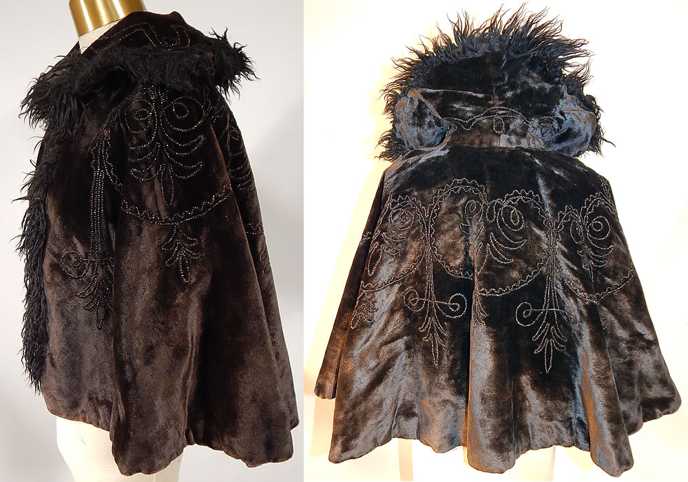 Victorian Black Velvet Jet Beaded Mohair Trim Winter Cloak Cape Mantle
 This antique Victorian era black velvet jet beaded mohair trim winter cloak cape mantle dates from 1880. It is made of a black heavy plush velvet fabric, with jet beading done in decorative designs and black mohair Angora goat curly fur trim edging around the collar and down the front opening.