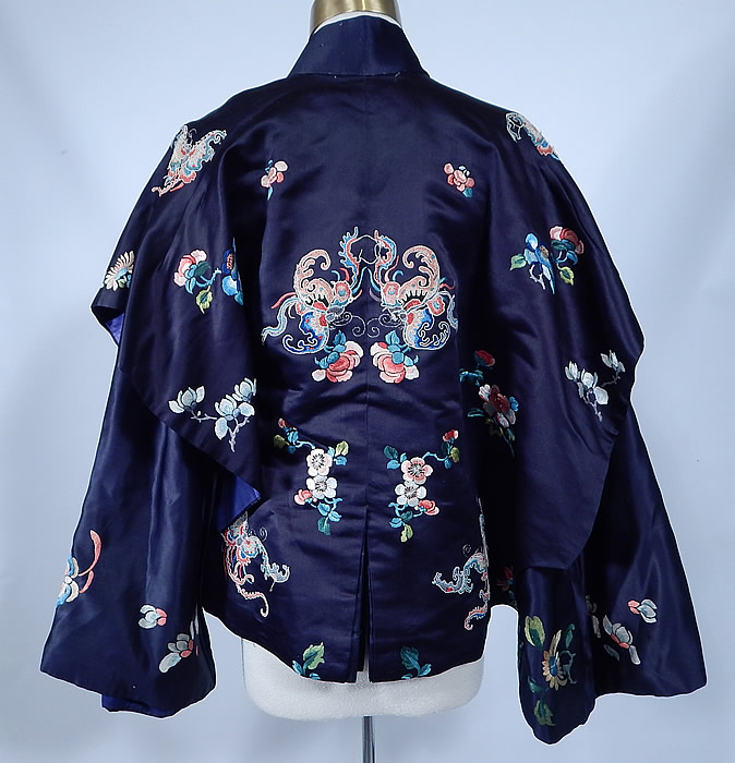 Antique Chinese Blue Silk Forbidden Stitch Embroidered Butterfly Robe Jacket
This magnificent Manchu womens robe appears to have been altered creating a short cropped capelet dolman mantle style robe jacket, with a fitted slit vent back, wide batwing armholes, with long full sleeves inside, flared wide cuffs, a mandarin collar, with hook, snap closures along the side and is fully lined, with a waistband tie strap.