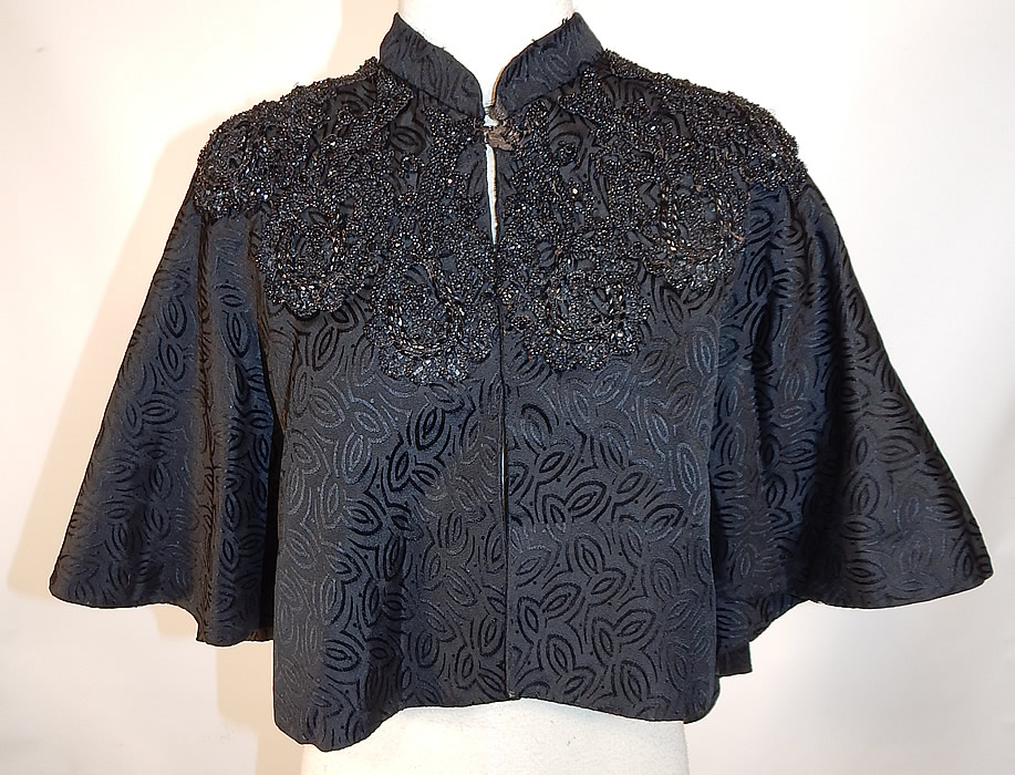 Victorian Black Silk Damask Brocade Jet Beaded Trim Mourning Cloak Cape
This antique Victorian era black silk damask brocade jet beaded trim mourning cloak cape capelet dates from 1880.
