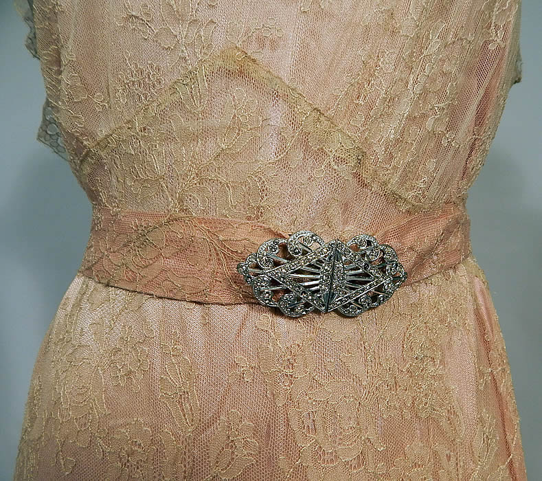 Vintage Cream Chantilly Lace Belted Bias Cut Dress Wedding Gown & Pink Silk Slip
This beautiful bias cut dress has a long floor length full skirt, high lace neckline yoke, short cap sleeves, plunging V back with lace shawl flounce collar, matching lace fabric belt with silver rhinestone buckle clasp closure and is sheer, unlined. 
