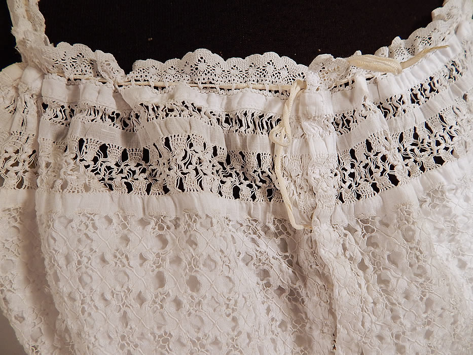Edwardian White Cotton Linen Drawnwork Lace Camisole Top & Full Slip Dress
This lovely lace lingerie undergarment two piece ensemble includes a camisole sleeveless top, with a crochet lace trim drawstring neckline, fitted waist with linen skirted bottom and snap closures down the front. 