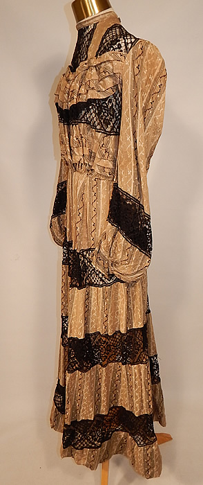 Victorian Brown & White Cotton Calico Striped Black Lace Trim Gown Dress
This beautiful summer tea gown dress is a long floor length, with a hemmed shortened full skirt, high neck collar, pleated, lace yoke trim top, long full bishop style sleeves with fitted cuffs, tiny black buttons, hooks for closure down the back and is sheer, unlined. The dress measures 51 inches long, with a 28 inch waist, 36 inch bust and 24 inch long sleeves. 