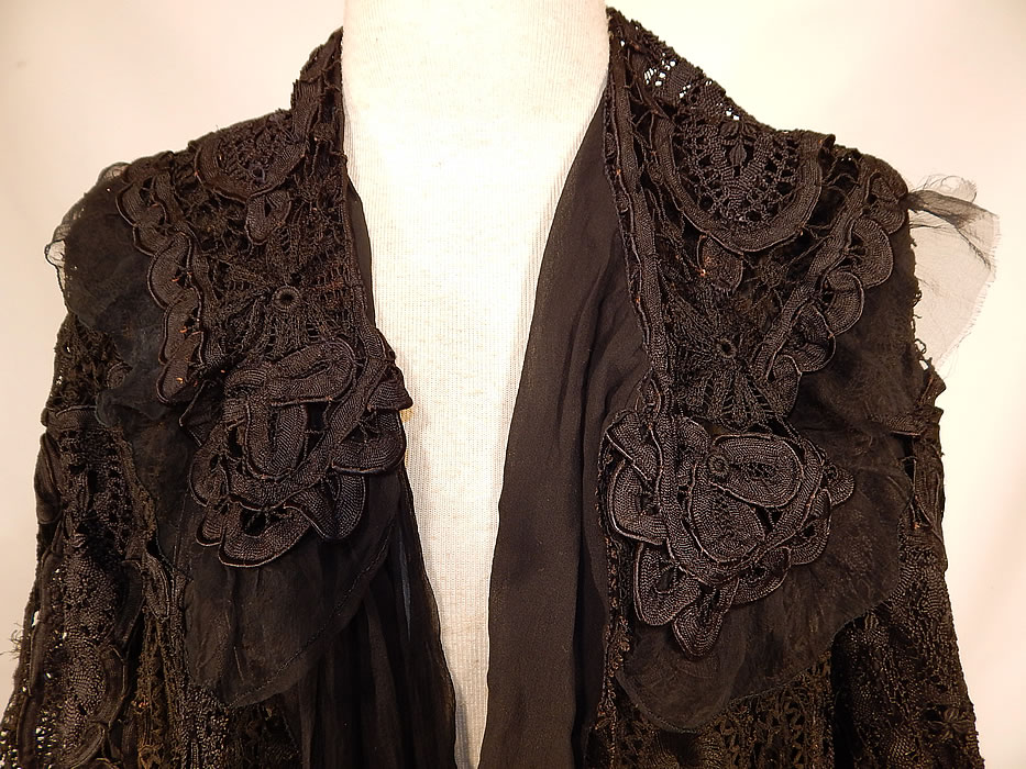 Edwardian Black Silk Battenburg Tape Lace Shawl Collar Long Coat Jacket
This lovely lace loose fitting coat jacket is a long length, with long full sleeves, a shawl collar, black silk chiffon lining inside, an attached neck scarf tie hanging down the front and open an front with no closure. The coat measures 42 inches long, with 46 inch hips, a 46 inch waist, 44 inch bust, 17 inch back and 25 inch long sleeves.