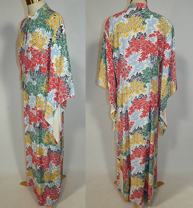 Vintage Liberty House Hawaiian Maple Leaf Print Rayon Pake Muu Muu Dress
This retro Hawaiian pake muu muu style long floor length loose fitting dress has slight shoulder padding, wide flared bat wing kimono sleeves lined in cream, a mandarin collar with toggle closure at the neck, key hole front opening, side slits on the skirt and side zipper closure. 