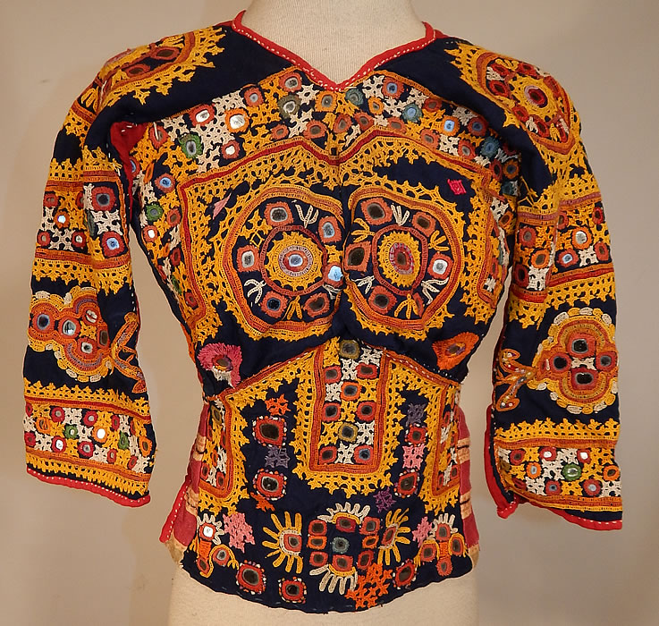 Vintage Antique Indian Gujarati Kutch Work Embroidered Mirror Choli Boho Blouse Top
This vintage antique Indian Gujarati kutch work colorful embroidered mirror choli boho blouse top dates from the early 1900s. It is made a hand dyed indigo blue and red linen fabric with vibrant colorful decorative crewel chain stitch kutch work embroidery done in the tribal folk patterns from Gujarati, Rajasthan India and Sindh Pakistan.