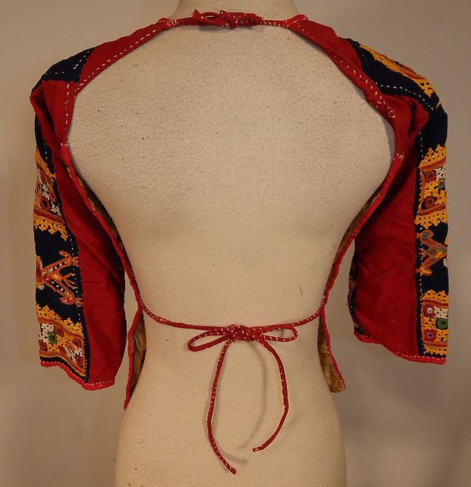 Vintage Antique Indian Gujarati Kutch Work Embroidered Mirror Choli Boho Blouse Top
The top measures 18 inches long, with a 26 inch bust, 22 inch waist and 12 inch long sleeves. 