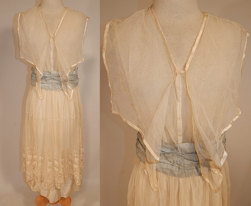 Edwardian White Net Embroidered Lace Sailor Middy Top Blue Sash Belted Dress
This vintage Edwardian era white net embroidered lace sailor middy top blue sash belted dress dates from 1915. It is made of a sheer fine white tulle net, with raised padded satin stitch embroidery work done in a floral pattern design along the bottom skirt. 