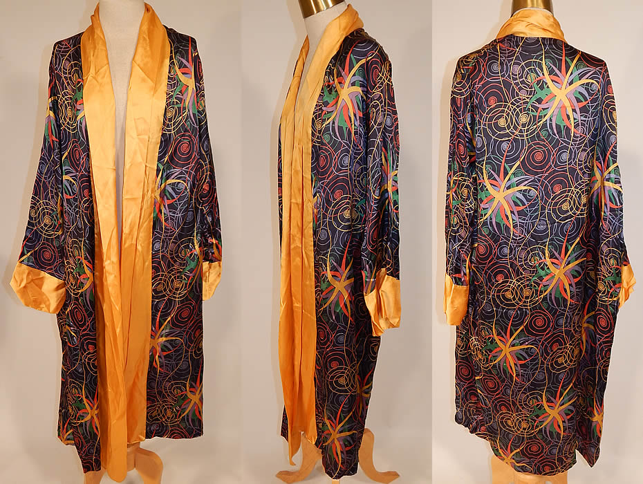 Vintage Art Deco Colorful Rainbow Spiral Stars Silk Flapper Kimono Robe Coat
This vintage Art Deco colorful rainbow spiral stars silk flapper kimono robe coat dates from the 1920s. It is made of a black silk rayon fabric, with a colorful rainbow spiral star silk screen print pattern design and golden yellow trim edging along the front opening and sleeve cuffs. This fabulous flapper kimono robe style coat is loose fitting, a long length, with a fold over collar lapel, long full sleeves, an open front with no closure and is unlined. 