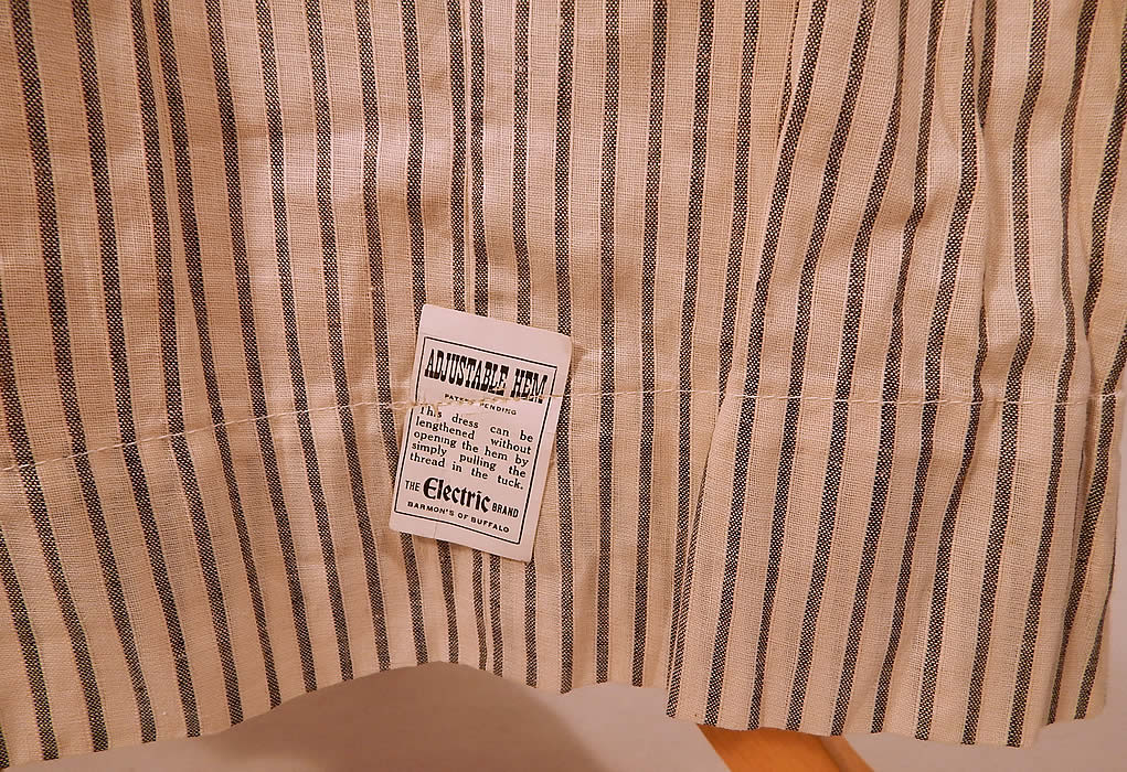 Edwardian Electric Brand Black & White Striped Cotton Workwear House Dress NWT
This womens work wear house dress has a long floor length, adjustable hem, asymmetrical button front closure, 3/4 length sleeves and is unlined. 