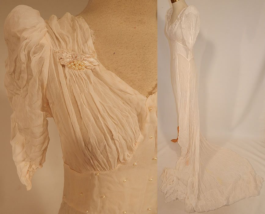 Vintage White Silk Crepe de Chine Pearl Beaded Wedding Gown Dress Long Train Skirt
 This beautiful bridal wedding gown dress has a sweetheart neckline, slightly padded shoulders, short puffy sleeves, a fitted waist, very long back train skirt with loop for carrying, silk covered button back closures and is sheer, unlined.