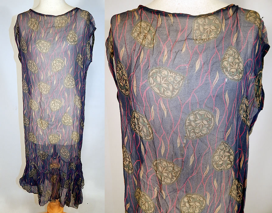 Vintage Art Deco Navy Blue Green Leaf Abstract Print Silk Chiffon Drop Waist Dress
This vintage Art Deco navy blue green leaf abstract print silk chiffon drop waist dress dates from the 1920s. It is made of a navy blue background, with pink and green abstract floral leaf print designs on the sheer silk chiffon fabric. 