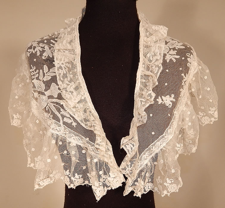 Victorian White Needlepoint Applique Lace Fichu Kerchief Scarf Shawl Collar Cape Pelerine
This Victorian era antique white needlepoint appliqu&eacute; lace fichu kerchief scarf shawl collar cape pelerine dates from the late 19th century. It is made of a sheer white needlepoint appliqu&eacute; lace done on machine made net in a floral leaf, polka dot design.