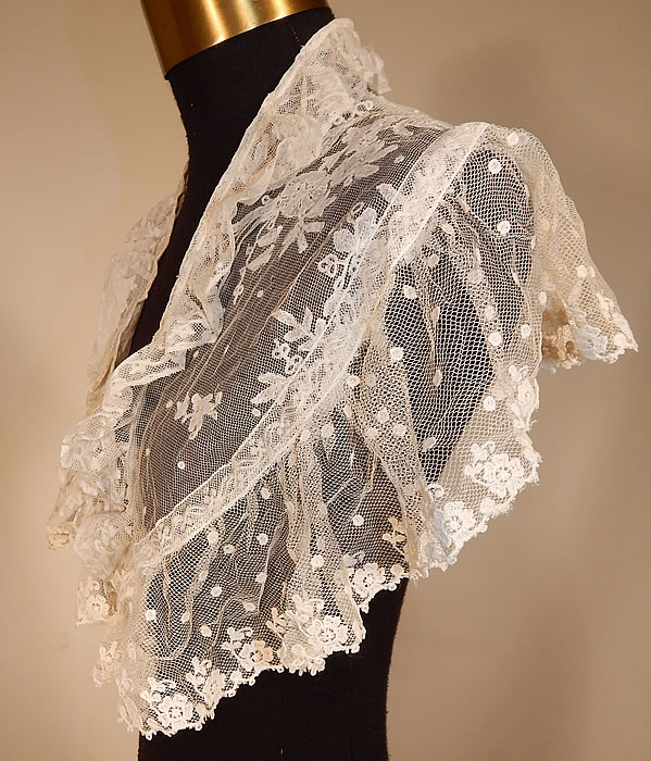 Victorian White Needlepoint Applique Lace Fichu Kerchief Scarf Shawl Collar Cape Pelerine
This lovely lace fichu kerchief scarf shawl collar capelet pelerine has a triangle shape, with scalloped ruffle trim bottom edging, fold over ruffle neckline, an open front with no closure and is sheer, unlined.