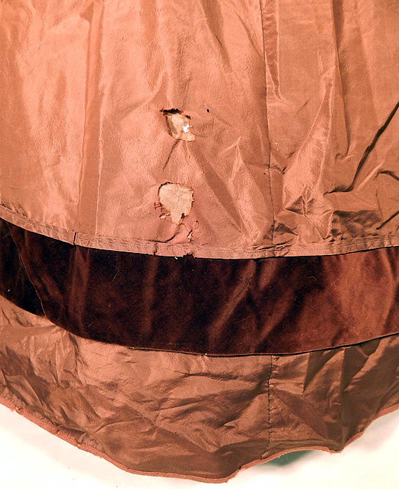 Victorian Civil War Era Brown Silk Taffeta Hoop Skirt Dress & Velvet Bow Belt Sash
The two piece outfit is in good condition, with only some slight underarm discoloration and two small frayed holes on the side skirt near the bottom (see close-up).